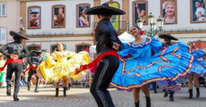 Crowds waving Mexican flags at Plaza Grande in Mérida during Independence Day
